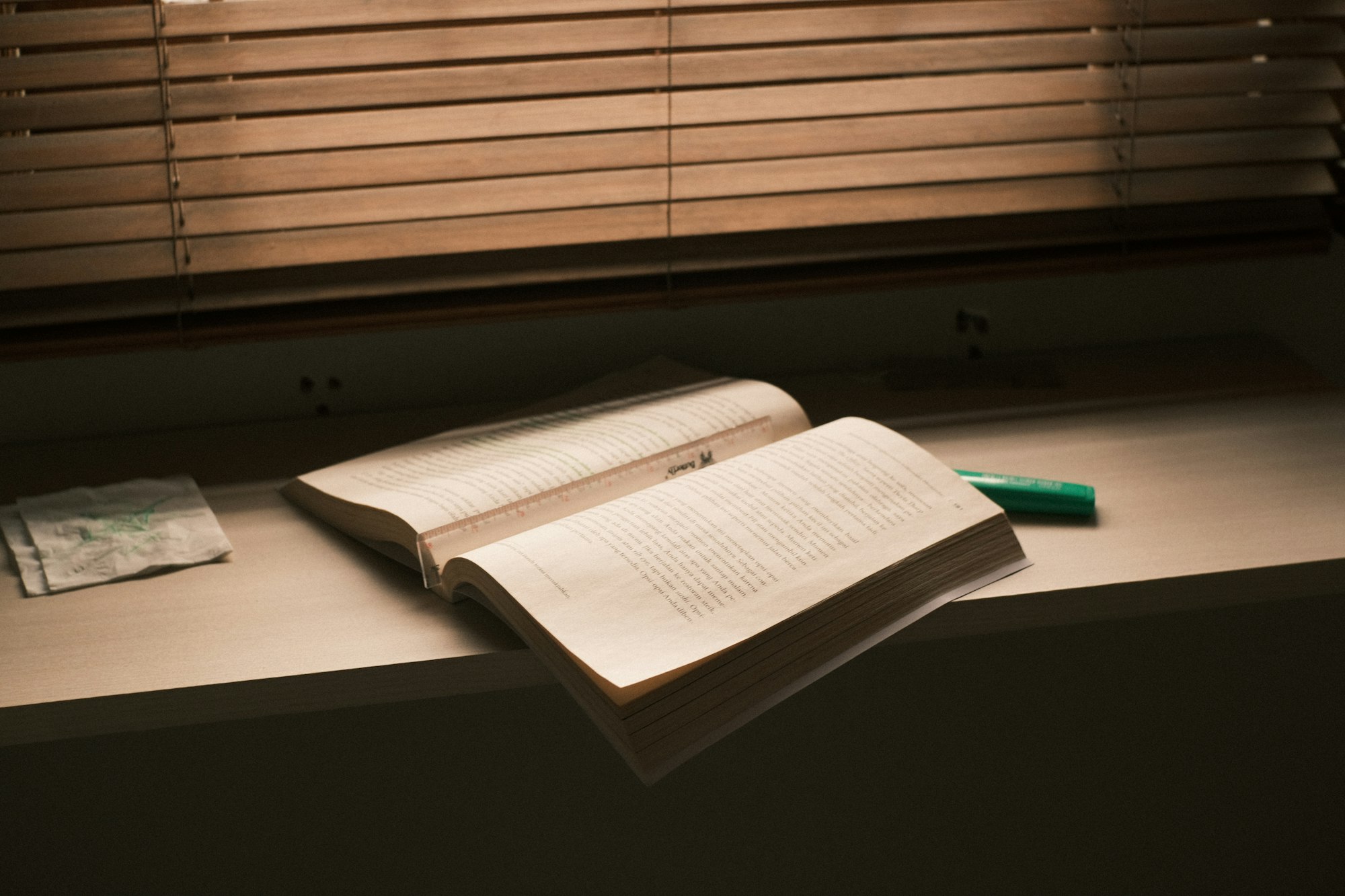 An open book on a windowsill in evening light